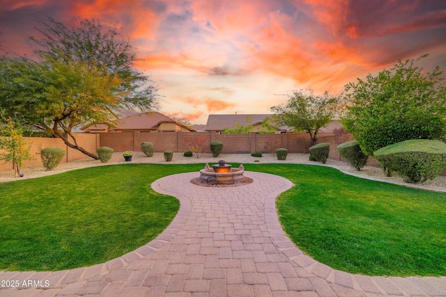 yard at dusk with an outdoor fire pit and a patio