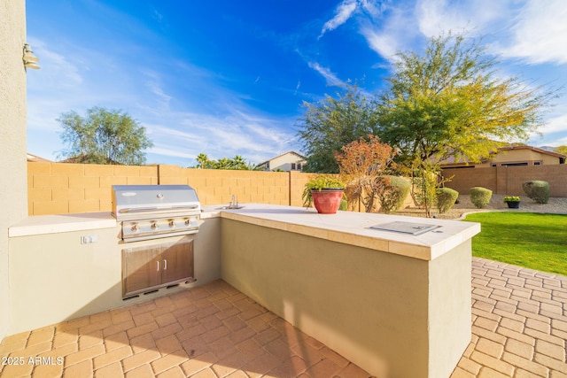 view of patio / terrace featuring an outdoor kitchen and area for grilling