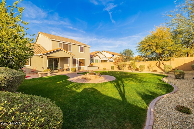 rear view of house with a patio area and a lawn