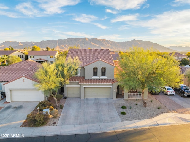 view of front of property featuring a garage and a mountain view