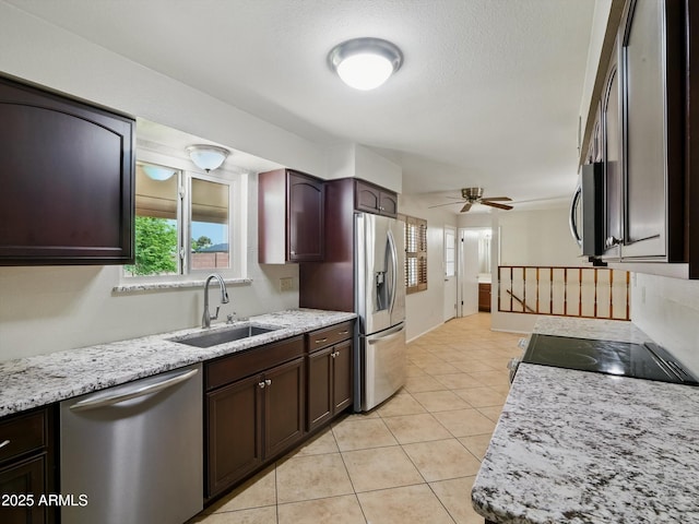 1306 W 12th St, Tempe, AZ 85281 - kitchen featuring appliances with stainless steel finishes, a ceiling fan, light tile patterned flooring, dark brown cabinetry, and light stone counters