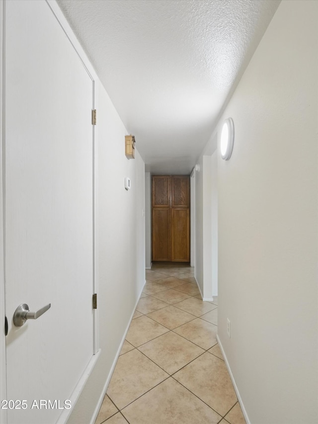 1306 W 12th St, Tempe, AZ 85281 - hallway featuring light tile patterned floors and a textured ceiling
