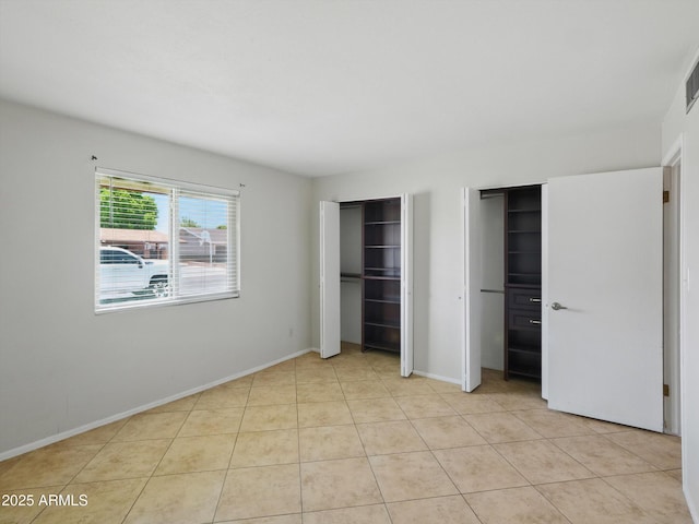 1306 W 12th St, Tempe, AZ 85281 - unfurnished bedroom featuring two closets and light tile patterned floors