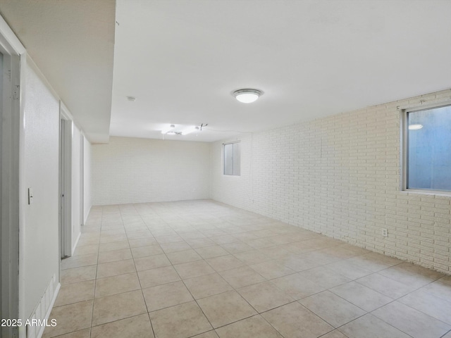 1306 W 12th St, Tempe, AZ 85281 - spare room with brick wall and light tile patterned flooring