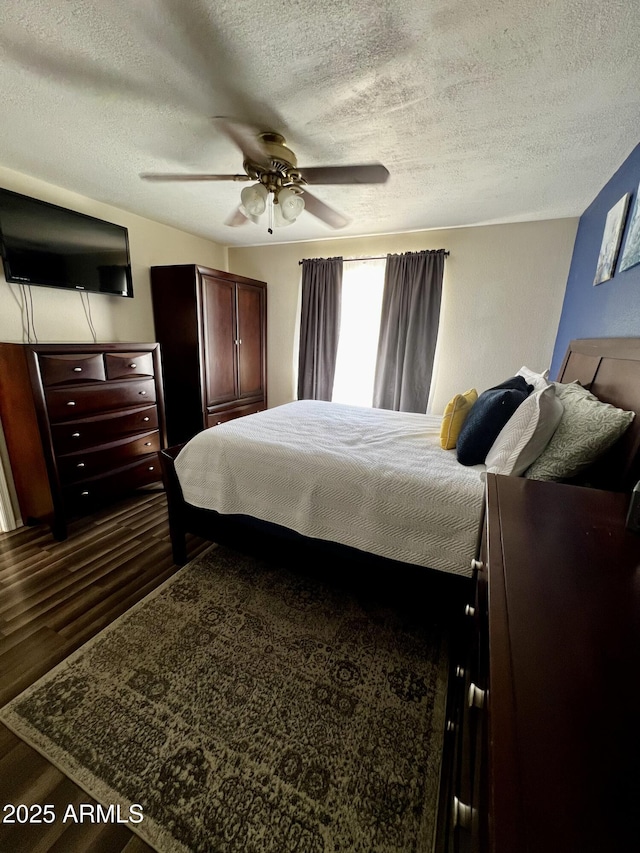 4767 W Wahalla Ln, Glendale, AZ 85308 - bedroom with a textured ceiling, dark wood-style flooring, and a ceiling fan