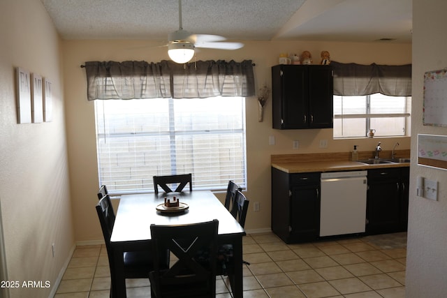 4767 W Wahalla Ln, Glendale, AZ 85308 - kitchen with dishwasher, ceiling fan, light tile patterned floors, light countertops, and dark cabinetry