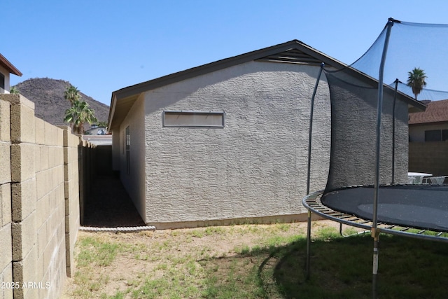 4767 W Wahalla Ln, Glendale, AZ 85308 - view of side of property featuring a trampoline and stucco siding
