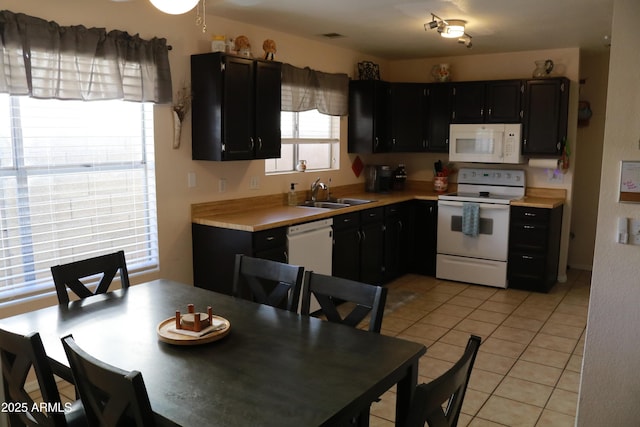 4767 W Wahalla Ln, Glendale, AZ 85308 - kitchen with white appliances, light countertops, light tile patterned floors, and dark cabinets