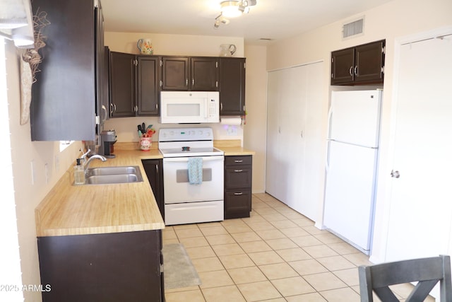 4767 W Wahalla Ln, Glendale, AZ 85308 - kitchen with white appliances, light countertops, dark brown cabinets, and light tile patterned flooring