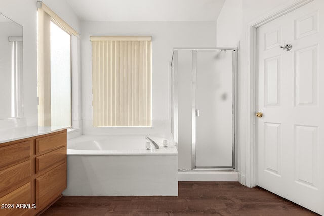 bathroom featuring hardwood / wood-style flooring and separate shower and tub