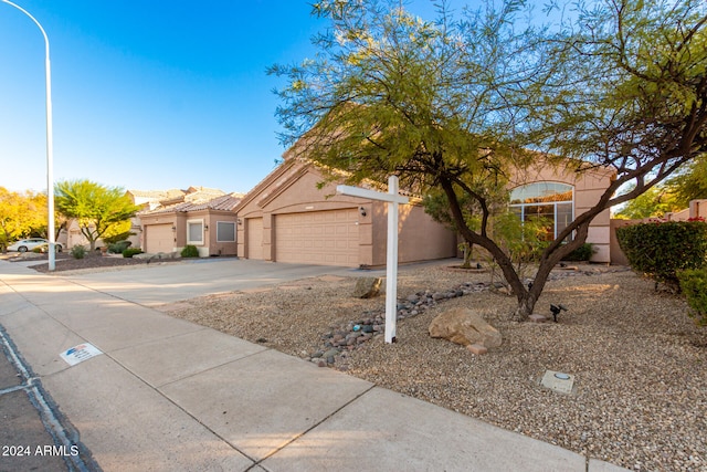 ranch-style home featuring a garage