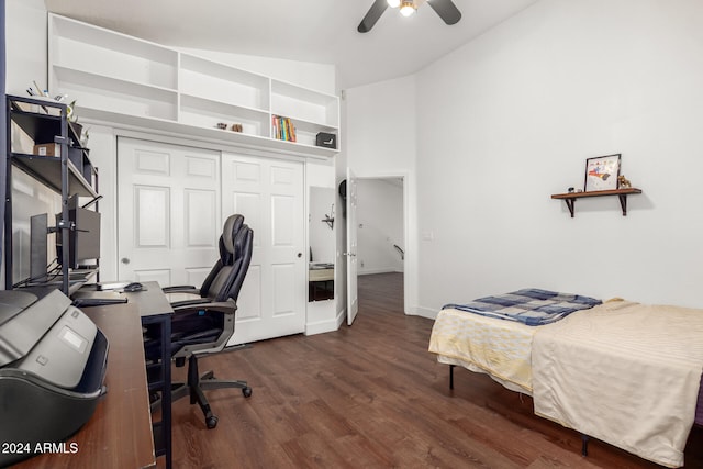 bedroom with ceiling fan, lofted ceiling, dark wood-type flooring, and a closet