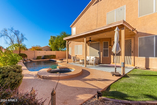 view of pool with a patio area, ceiling fan, and an in ground hot tub