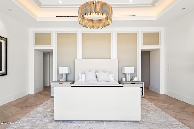 bedroom featuring a tray ceiling and light parquet flooring