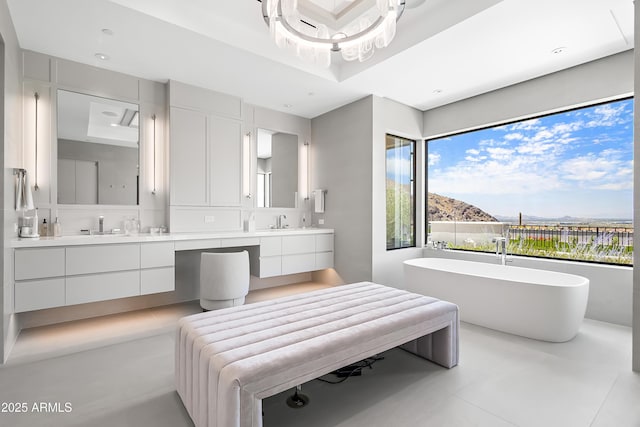 bathroom with vanity, a mountain view, and a bathing tub