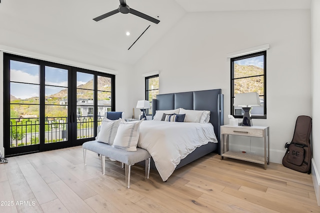 bedroom featuring ceiling fan, high vaulted ceiling, light hardwood / wood-style flooring, and access to outside