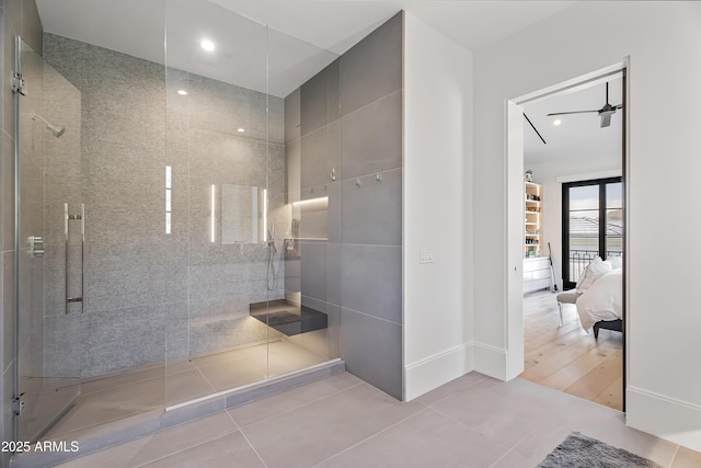 bathroom with tile patterned flooring and a tile shower