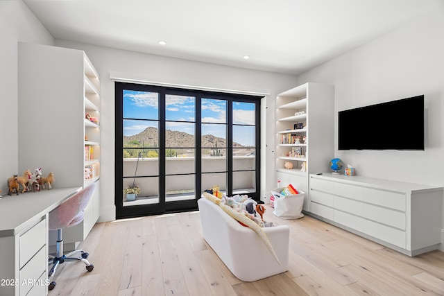 interior space featuring built in desk, light hardwood / wood-style flooring, and access to outside