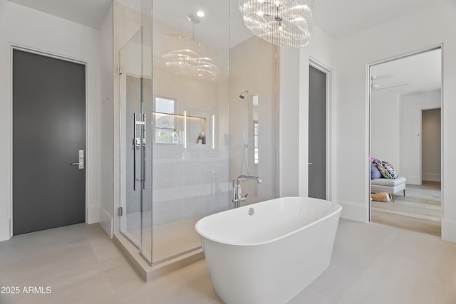 bathroom with plus walk in shower and a notable chandelier