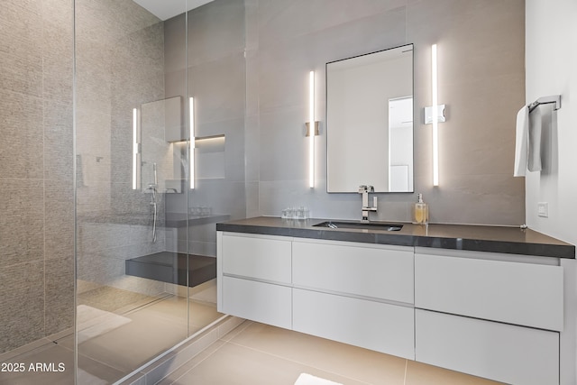 bathroom with vanity, a shower with shower door, and tile patterned floors