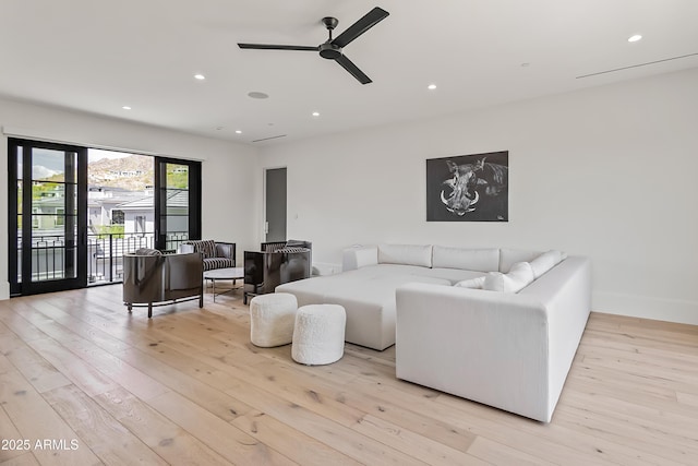 living room featuring ceiling fan and light wood-type flooring