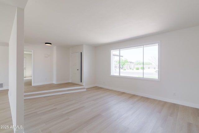 14803 N 55th Ave, Glendale, AZ 85306 - unfurnished living room featuring light wood-style flooring, baseboards, and visible vents