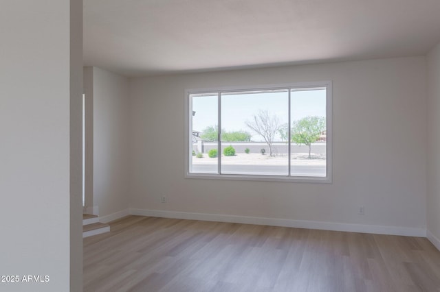 14803 N 55th Ave, Glendale, AZ 85306 - empty room with light wood finished floors and baseboards