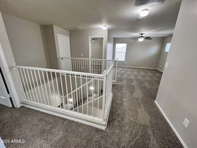 corridor with dark colored carpet