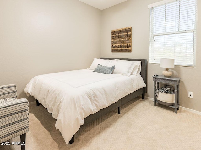 bedroom with carpet, multiple windows, and baseboards