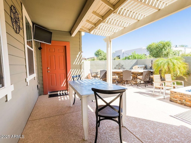 view of patio with an outdoor fire pit, fence, a pergola, and outdoor dining space