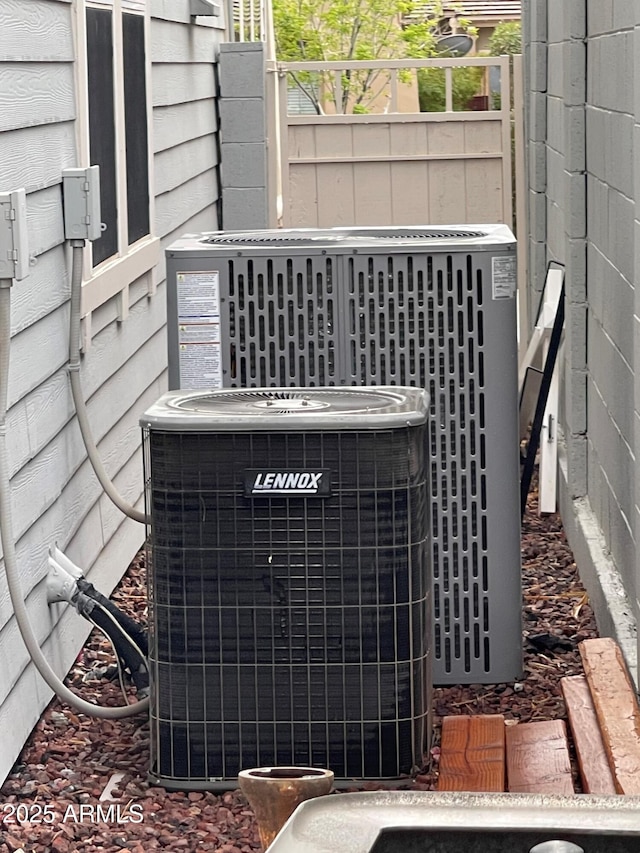 details featuring cooling unit and fence