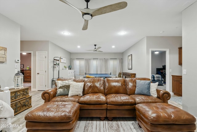 living room featuring light wood finished floors, ceiling fan, baseboards, and recessed lighting