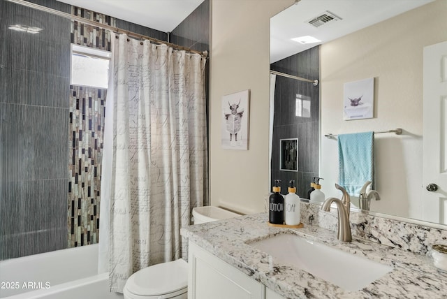 full bathroom with vanity, shower / bath combination with curtain, and toilet