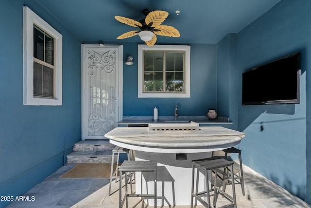 view of patio featuring an outdoor wet bar and ceiling fan