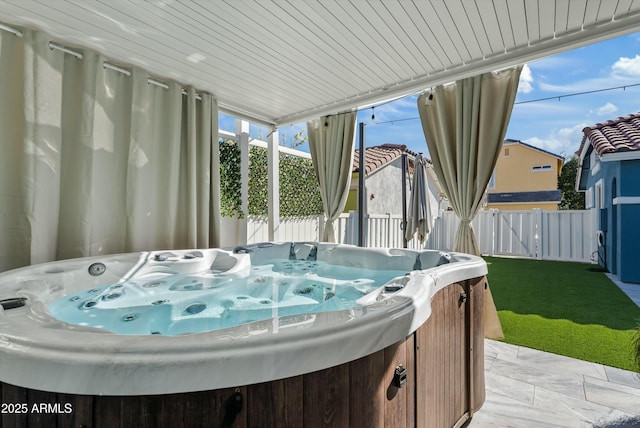 sunroom featuring wood ceiling and a jacuzzi