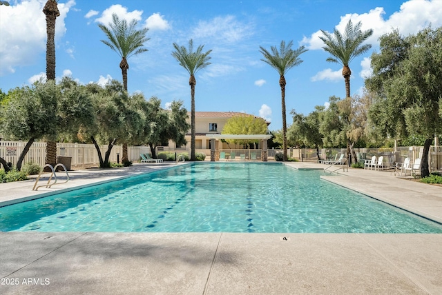 pool featuring a patio area and fence