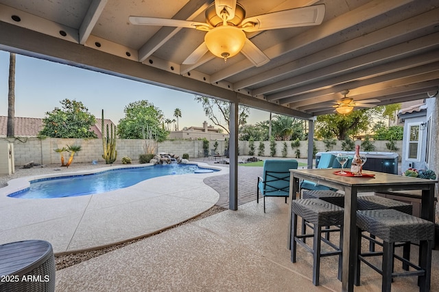 view of swimming pool with ceiling fan and a patio