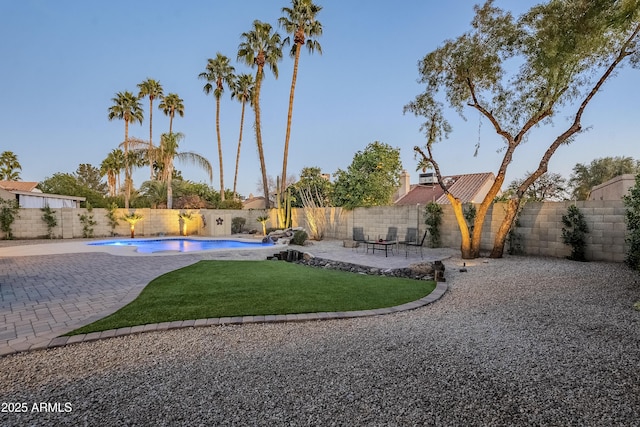 view of yard featuring a fenced in pool and a patio