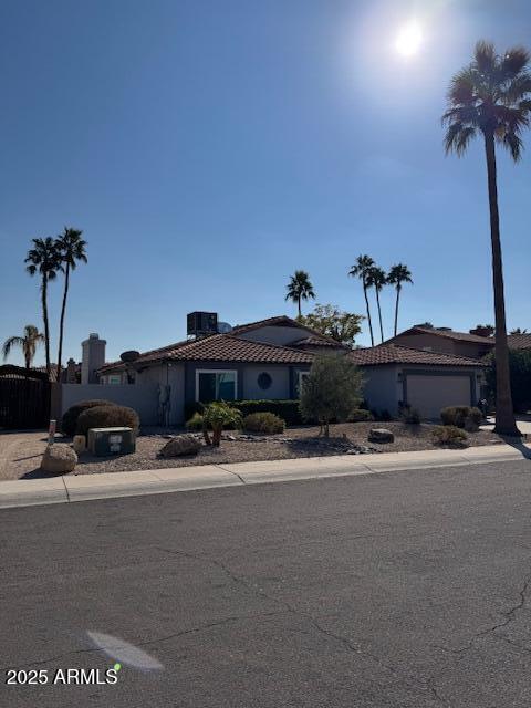 view of front of home featuring cooling unit and a garage