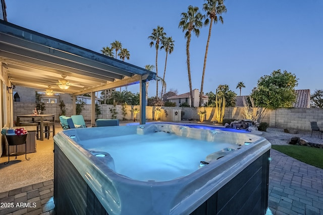 view of pool with ceiling fan, a hot tub, and a patio