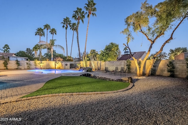 view of yard featuring a fenced in pool and a patio