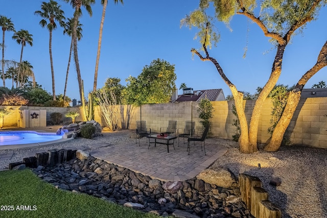 view of patio with a fenced in pool and an outdoor fire pit