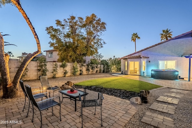 view of patio / terrace with a hot tub