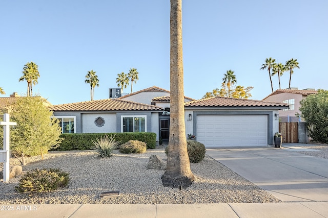 mediterranean / spanish-style house with a garage