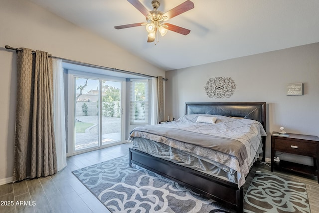 bedroom with hardwood / wood-style floors, lofted ceiling, access to outside, and ceiling fan