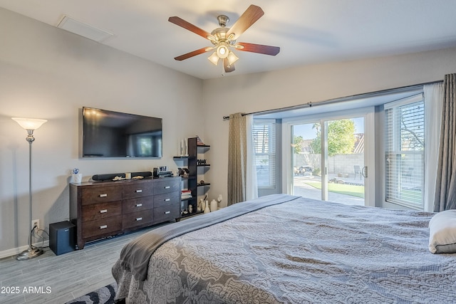 bedroom with access to exterior, light hardwood / wood-style floors, and ceiling fan