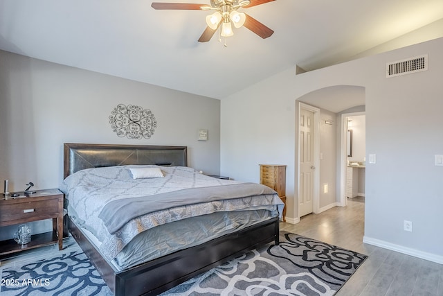 bedroom featuring ceiling fan, lofted ceiling, and wood-type flooring