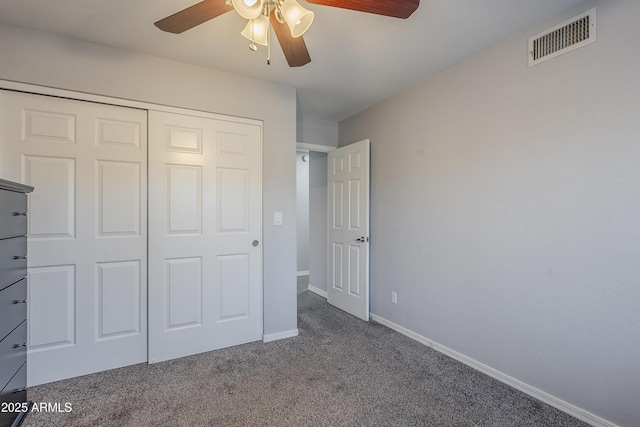 unfurnished bedroom featuring ceiling fan, carpet floors, and a closet