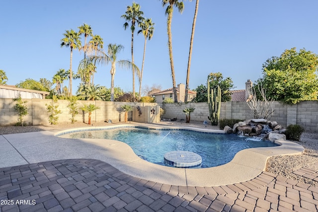 view of pool with pool water feature and a patio area