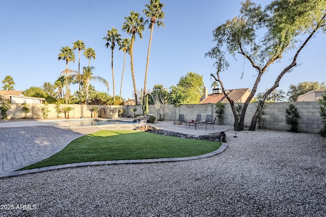 view of yard featuring a fenced in pool and a patio area